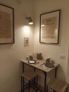 a table in a room with two stools and a table at La Casina b&b in Ancona