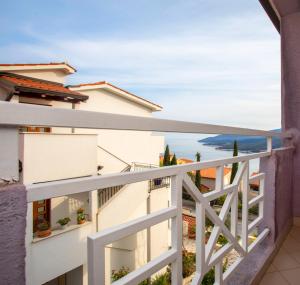 a balcony with a view of the ocean at Sea view apartment with private parking place in Rabac