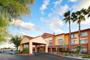 an exterior view of a hotel with palm trees at SpringHill Suites Tempe at Arizona Mills Mall in Tempe