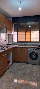 a kitchen with a washer and a washing machine at Tamraght agadir in Tamraght Ouzdar