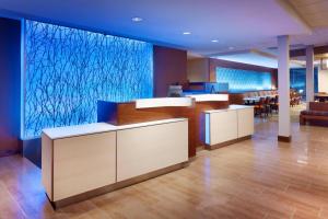 an empty lobby with a large painting on the wall at Fairfield Inn & Suites by Marriott Salt Lake City Midvale in Midvale