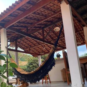 a hammock hanging from awning in a house at Fazenda do Quartel in Manhumirim