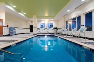 a large swimming pool with chairs and a pool at Fairfield Inn & Suites Seattle Bremerton in Bremerton