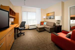 ein Hotelzimmer mit einem Sofa und einem Wohnzimmer in der Unterkunft TownePlace Suites by Marriott Lexington Park Patuxent River Naval Air Station in Lexington Park