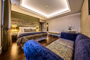 a hotel room with two beds and a couch at Prestige Hotel Budapest in Budapest