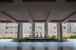 a view of a building with a fountain in a courtyard at Five H Family Service Apartment in Seri Kembangan