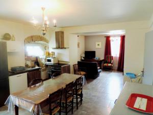 a kitchen and living room with a table and a dining room at Majestic holiday home in Les Assions with terrace in Les Assions