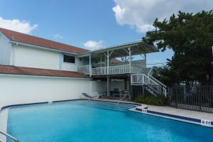 a swimming pool in front of a house at Inn at Camachee Harbor View 22 in Saint Augustine