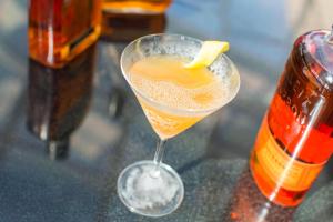 a drink in a glass with a lemon slice in it at Marriott Philadelphia West in West Conshohocken