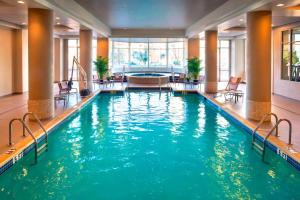 a swimming pool in a hotel with blue water at Marriott Philadelphia West in West Conshohocken