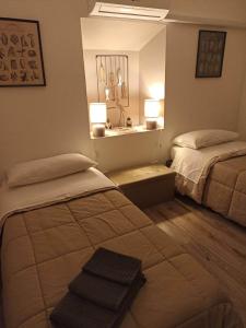 a hotel room with two beds and a sink at La Casina b&b in Ancona