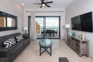 a living room with a couch and a table at Luxury Oceanview Condo - Las Palomas - Pool, Golf, Sandy Beach ! in Puerto Peñasco