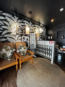 a living room with a couch and a wall at Check-Inn at Little India in Singapore