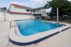 a large swimming pool in front of a house at Inn at Camachee Harbor View Suite 27 in Saint Augustine