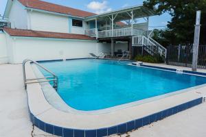 a large blue swimming pool in front of a house at Inn at Camachee Harbor View 24 in Saint Augustine