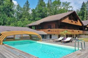 a house with a swimming pool in front of a house at Chalet Esprit in Morillon