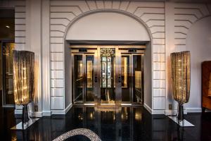 an entrance to a building with an archway and lights at Prestige Hotel Budapest in Budapest