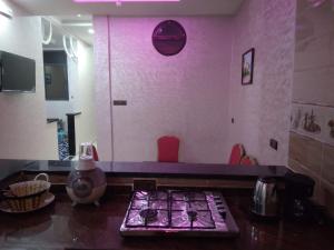 a kitchen with a counter with a pink wall at Dream House Sidi Ifni in Sidi Ifni