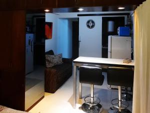 a kitchen with a counter and two bar stools at Departamento Macro in Mendoza