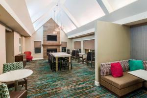 a living room with a couch and tables and chairs at Residence Inn Macon in Macon