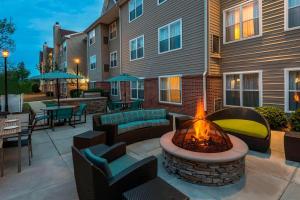 a patio with a fire pit in front of a building at Residence Inn Macon in Macon