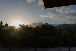 a view of the sun setting over the mountains at Martim de Sá - Caragua in Caraguatatuba