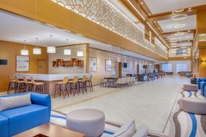 a lobby of a hospital with chairs and a bar at Residence Inn by Marriott Dammam in Dammam