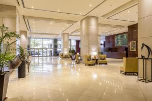 a lobby of a hotel with chairs and tables at Sheraton Mendoza Hotel in Mendoza