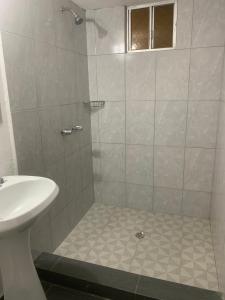 a bathroom with a shower and a sink at Hotel Dorado Baja in Mexicali