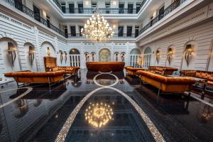 a large lobby filled with lots of tables and chairs at Prestige Hotel Budapest in Budapest