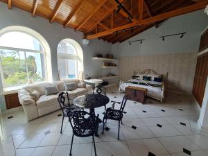 een woonkamer met een bank en een tafel en stoelen bij Casa Blanca del Mar in Santa Marta