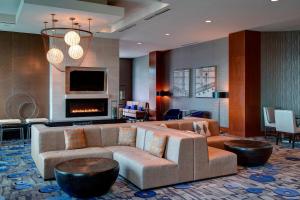 a living room with a couch and a fireplace at Seattle Marriott Waterfront in Seattle