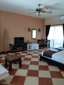 a bedroom with a bed and a checkered floor at Liam's Guesthouse Adults Only in Chiang Mai