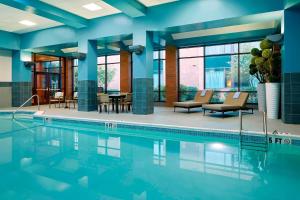 a swimming pool in a hotel room with blue walls at Marriott Hartford/Windsor Airport in Windsor