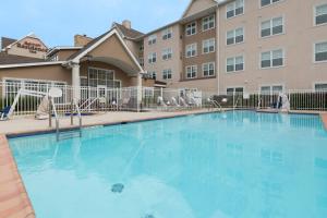 a large swimming pool in front of a building at Residence Inn by Marriott Baton Rouge near LSU in Baton Rouge