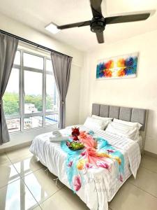 a bedroom with a bed with a table with food on it at Ipoh Majestic Condo by D&A homes in Ipoh