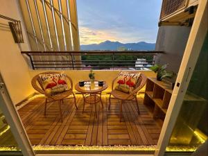 a balcony with two chairs and a table on a balcony at Ipoh Majestic Condo by D&A homes in Ipoh