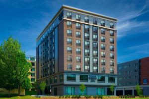 a tall brick building with many windows at Fairfield by Marriott Inn & Suites Boston Medford in Medford