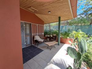 a patio with awning and a table and chairs at Casa Mapache in Tamarindo