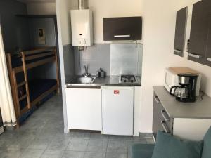 een kleine keuken met een wastafel en een magnetron bij Studio Cap d'Agde, 2 pièces, 4 personnes - FR-1-723-28 in Cap d'Agde