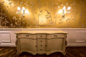 a gold dresser in a room with a wall at Prestige Hotel Budapest in Budapest