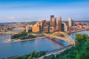 a view of a city with a bridge over a river at Family-Friendly 4BR Retreat Sleeps 12, Private Yard, Garage, Close to Stadiums, Casino & Downtown in Pittsburgh