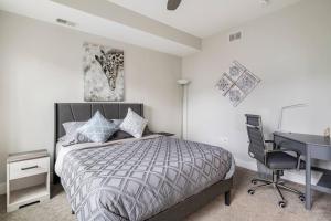 a bedroom with a bed and a desk and a computer at Family-Friendly 4BR Retreat Sleeps 12, Private Yard, Garage, Close to Stadiums, Casino & Downtown in Pittsburgh