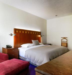 une chambre d'hôtel avec deux lits et un canapé dans l'établissement Camino Real Polanco Mexico, à Mexico