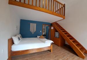 a bedroom with a bunk bed with a staircase at Ong Lang Bay Resort in Phú Quốc
