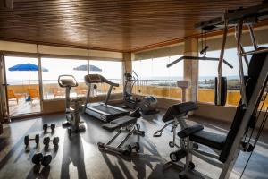 a gym with cardio equipment in a room with a view at Grand Hotel Continental in Tirrenia