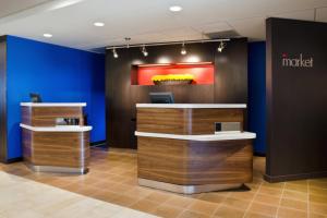 a lobby of a hotel with blue walls and a counter at Courtyard St. Louis Airport/Earth City in Bridgeton