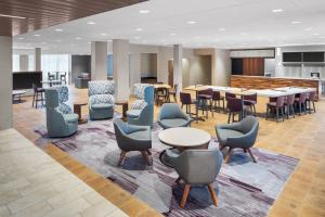 a lobby with tables and chairs and a cafeteria at Courtyard by Marriott Wayne Fairfield in Wayne