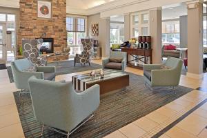 a lobby with chairs and a living room at Residence Inn by Marriott Loveland Fort Collins in Loveland