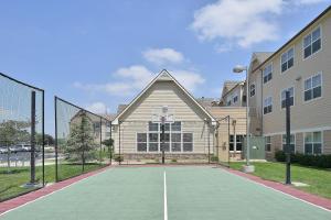 a tennis court in front of a house at Residence Inn by Marriott Loveland Fort Collins in Loveland